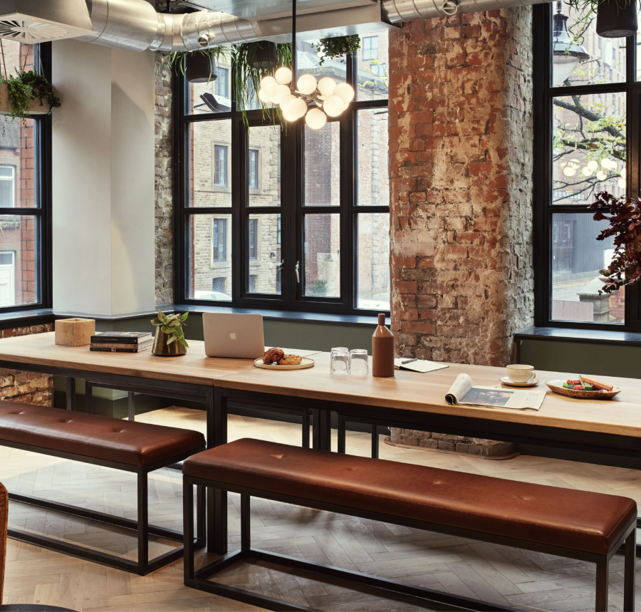Restored brick interior at LEVEN Manchester with bespoke timber dining tables